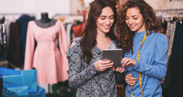 Two young designers work together using a tablet.